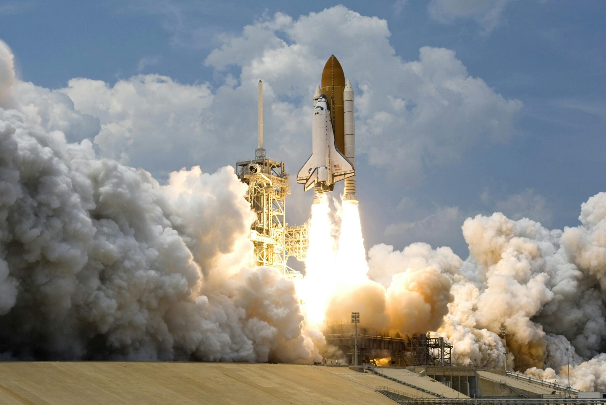 Witness the powerful launch of a space shuttle amidst massive clouds of smoke against a bright sky.